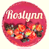 Beautifully decorated red velvet berry birthday cake with vibrant fruits and a glowing 'Roslynn' name, adding a touch of sweetness and sparkle.