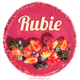Beautifully decorated red velvet berry birthday cake with vibrant fruits and a glowing 'Rubie' name, adding a touch of sweetness and sparkle.