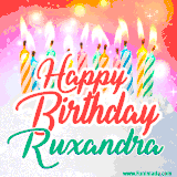 Bright birthday candles with rainbow flames on a cake, alongside the text 'Happy Birthday Ruxandra' in vibrant script in this celebratory animated GIF.