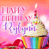 A vibrant birthday GIF featuring a rainbow-colored cupcake topped with white frosting, sprinkles, and a lit candle. The text reads 'Happy Birthday Rylynn' in bold pink and violet letters with white outline.