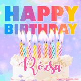 A vibrant animated name GIF with the words 'Happy Birthday Rózsa' with colorful candles on a creamy cake. The background sparkles with pastel shades, adding a festive touch.