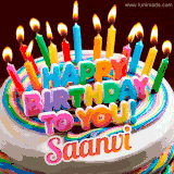 A colorful birthday cake topped with lit candles, with the words 'Happy Birthday Saanvi' in bold glowing letters on a burgundy background. Animated flames add a festive touch.