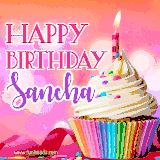 A vibrant birthday GIF featuring a rainbow-colored cupcake topped with white frosting, sprinkles, and a lit candle. The text reads 'Happy Birthday Sancha' in bold pink and violet letters with white outline.