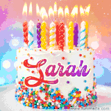 A cheerful white birthday cake with multicolor sprinkles, lit candles, and 'Sarah' written in vibrant letters, in an animated GIF.
