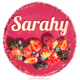 Beautifully decorated red velvet berry birthday cake with vibrant fruits and a glowing 'Sarahy' name, adding a touch of sweetness and sparkle.