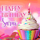 A vibrant birthday GIF featuring a rainbow-colored cupcake topped with white frosting, sprinkles, and a lit candle. The text reads 'Happy Birthday Sarai' in bold pink and violet letters with white outline.