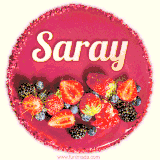 Beautifully decorated red velvet berry birthday cake with vibrant fruits and a glowing 'Saray' name, adding a touch of sweetness and sparkle.