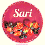 Beautifully decorated red velvet berry birthday cake with vibrant fruits and a glowing 'Sari' name, adding a touch of sweetness and sparkle.