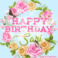 A charming animated GIF featuring 'Happy Birthday Sari' in pink and green text, surrounded by delicate roses, leaves, and fluttering butterflies on a soft light blue pastel background.