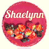 Beautifully decorated red velvet berry birthday cake with vibrant fruits and a glowing 'Shaelynn' name, adding a touch of sweetness and sparkle.