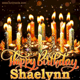 A glowing personalized birthday GIF with name Shaelynn featuring lit candles with intricate designs, warm lighting, and the text 'Happy Birthday' in an elegant font.