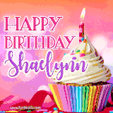 A vibrant birthday GIF featuring a rainbow-colored cupcake topped with white frosting, sprinkles, and a lit candle. The text reads 'Happy Birthday Shaelynn' in bold pink and violet letters with white outline.