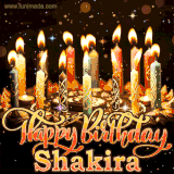 A glowing personalized birthday GIF with name Shakira featuring lit candles with intricate designs, warm lighting, and the text 'Happy Birthday' in an elegant font.
