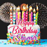 A lively happy birthday animated GIF showcasing a colorful birthday cake covered in sprinkles, topped with glowing candles, and surrounded by vibrant fireworks. The name 'Shamir' is featured in elegant script.