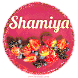 Beautifully decorated red velvet berry birthday cake with vibrant fruits and a glowing 'Shamiya' name, adding a touch of sweetness and sparkle.