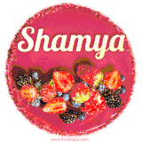 Beautifully decorated red velvet berry birthday cake with vibrant fruits and a glowing 'Shamya' name, adding a touch of sweetness and sparkle.