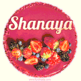 Beautifully decorated red velvet berry birthday cake with vibrant fruits and a glowing 'Shanaya' name, adding a touch of sweetness and sparkle.