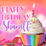 A vibrant birthday GIF featuring a rainbow-colored cupcake topped with white frosting, sprinkles, and a lit candle. The text reads 'Happy Birthday Shanell' in bold pink and violet letters with white outline.
