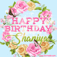 A charming animated GIF featuring 'Happy Birthday Shaniya' in pink and green text, surrounded by delicate roses, leaves, and fluttering butterflies on a soft light blue pastel background.