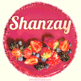 Beautifully decorated red velvet berry birthday cake with vibrant fruits and a glowing 'Shanzay' name, adding a touch of sweetness and sparkle.