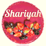 Beautifully decorated red velvet berry birthday cake with vibrant fruits and a glowing 'Shariyah' name, adding a touch of sweetness and sparkle.