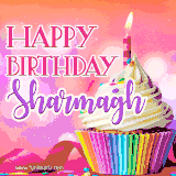 A vibrant birthday GIF featuring a rainbow-colored cupcake topped with white frosting, sprinkles, and a lit candle. The text reads 'Happy Birthday Sharmagh' in bold pink and violet letters with white outline.