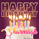 A colorful birthday cake topped with lit candles, with the words 'Happy Birthday Sharmagh' in bold glowing letters on a burgundy background. Animated flames add a festive touch.