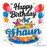 White drip cake on a blue platter with the name Shaun, surrounded by confetti, colorful hearts, and balloons.