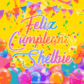 A bright and festive GIF with the text 'Feliz Cumpleaños Shelbie' in Spanish in colorful fonts, surrounded by confetti, balloons, and festive banners on a vibrant yellow background.