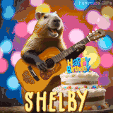 Animated birthday GIF showing a capybara playing guitar and singing beside a birthday cake with the name Shelby in large letters and colorful bokeh lights in the background.
