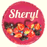 Beautifully decorated red velvet berry birthday cake with vibrant fruits and a glowing 'Sheryl' name, adding a touch of sweetness and sparkle.