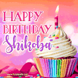 A vibrant birthday GIF featuring a rainbow-colored cupcake topped with white frosting, sprinkles, and a lit candle. The text reads 'Happy Birthday Shikoba' in bold pink and violet letters with white outline.