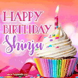 A vibrant birthday GIF featuring a rainbow-colored cupcake topped with white frosting, sprinkles, and a lit candle. The text reads 'Happy Birthday Shinju' in bold pink and violet letters with white outline.