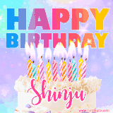 A vibrant animated name GIF with the words 'Happy Birthday Shinju' with colorful candles on a creamy cake. The background sparkles with pastel shades, adding a festive touch.