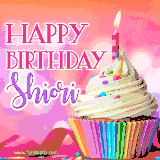 A vibrant birthday GIF featuring a rainbow-colored cupcake topped with white frosting, sprinkles, and a lit candle. The text reads 'Happy Birthday Shiori' in bold pink and violet letters with white outline.