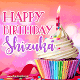 A vibrant birthday GIF featuring a rainbow-colored cupcake topped with white frosting, sprinkles, and a lit candle. The text reads 'Happy Birthday Shizuka' in bold pink and violet letters with white outline.