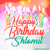 Bright birthday candles with rainbow flames on a cake, alongside the text 'Happy Birthday Shlomit' in vibrant script in this celebratory animated GIF.