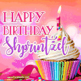 A vibrant birthday GIF featuring a rainbow-colored cupcake topped with white frosting, sprinkles, and a lit candle. The text reads 'Happy Birthday Shprintzel' in bold pink and violet letters with white outline.
