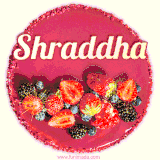 Beautifully decorated red velvet berry birthday cake with vibrant fruits and a glowing 'Shraddha' name, adding a touch of sweetness and sparkle.