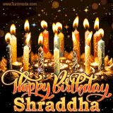 A glowing personalized birthday GIF with name Shraddha featuring lit candles with intricate designs, warm lighting, and the text 'Happy Birthday' in an elegant font.