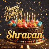 Yellow script spelling the name Shravan on a classic chocolate cake with a dark glaze under warm candlelight.