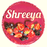 Beautifully decorated red velvet berry birthday cake with vibrant fruits and a glowing 'Shreeya' name, adding a touch of sweetness and sparkle.