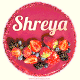 Beautifully decorated red velvet berry birthday cake with vibrant fruits and a glowing 'Shreya' name, adding a touch of sweetness and sparkle.
