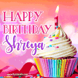 A vibrant birthday GIF featuring a rainbow-colored cupcake topped with white frosting, sprinkles, and a lit candle. The text reads 'Happy Birthday Shreya' in bold pink and violet letters with white outline.
