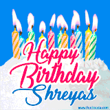 A cheerful animated GIF featuring colorful lit birthday candles on a white cake, with the text 'Happy Birthday Shreyas' in bold red and blue script on a bright blue background.