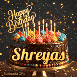 Burning birthday candles on top of a chocolate drip cake decorated with colorful icing dollops and sprinkles, personalized for Shreyas.