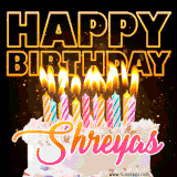 A vibrant animated GIF featuring a delicious birthday cake topped with glowing candles and the name 'Shreyas' in elegant script, and the words 'Happy Birthday' on the black background.