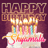 A colorful birthday cake topped with lit candles, with the words 'Happy Birthday Shyamala' in bold glowing letters on a burgundy background. Animated flames add a festive touch.