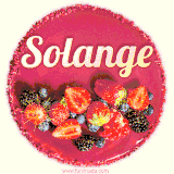 Beautifully decorated red velvet berry birthday cake with vibrant fruits and a glowing 'Solange' name, adding a touch of sweetness and sparkle.