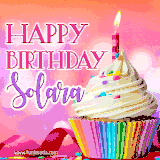 A vibrant birthday GIF featuring a rainbow-colored cupcake topped with white frosting, sprinkles, and a lit candle. The text reads 'Happy Birthday Solara' in bold pink and violet letters with white outline.